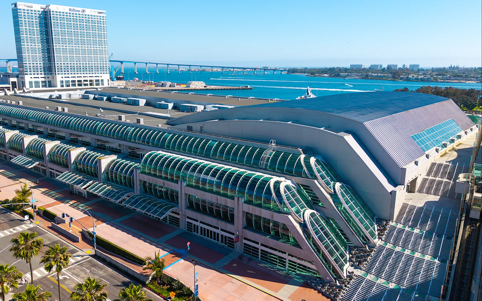 Aerial view of the San Diego Convention Center with bay and Coronado Bridge